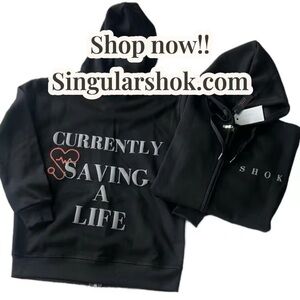 Singular Shok “Currently Saving A Life” Zip Up Black Hoodie.